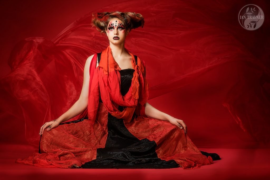 "Red on red" Creative fashion photo shoot by Ian Trayner. Model is Cerys Wrigley Moss. Designer is Lind Blissett. Studio photo shoot in Kingston.