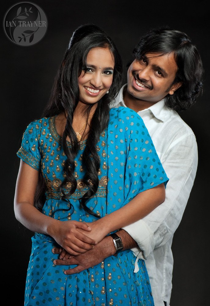 Happy romantic family photo of married asian couple, photographed in the studio.