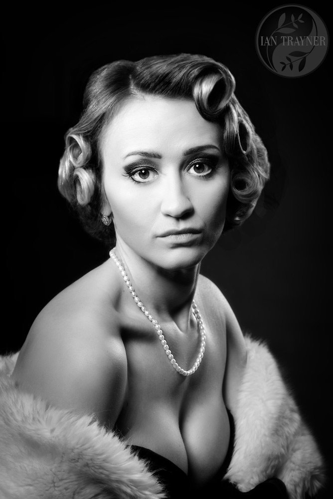 Creative and artistic photo portraits. Beautiful glamorous model shot using Hollywood lighting. Photo noir.