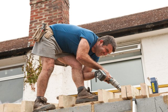 Cheerful builder. Don't fall off!